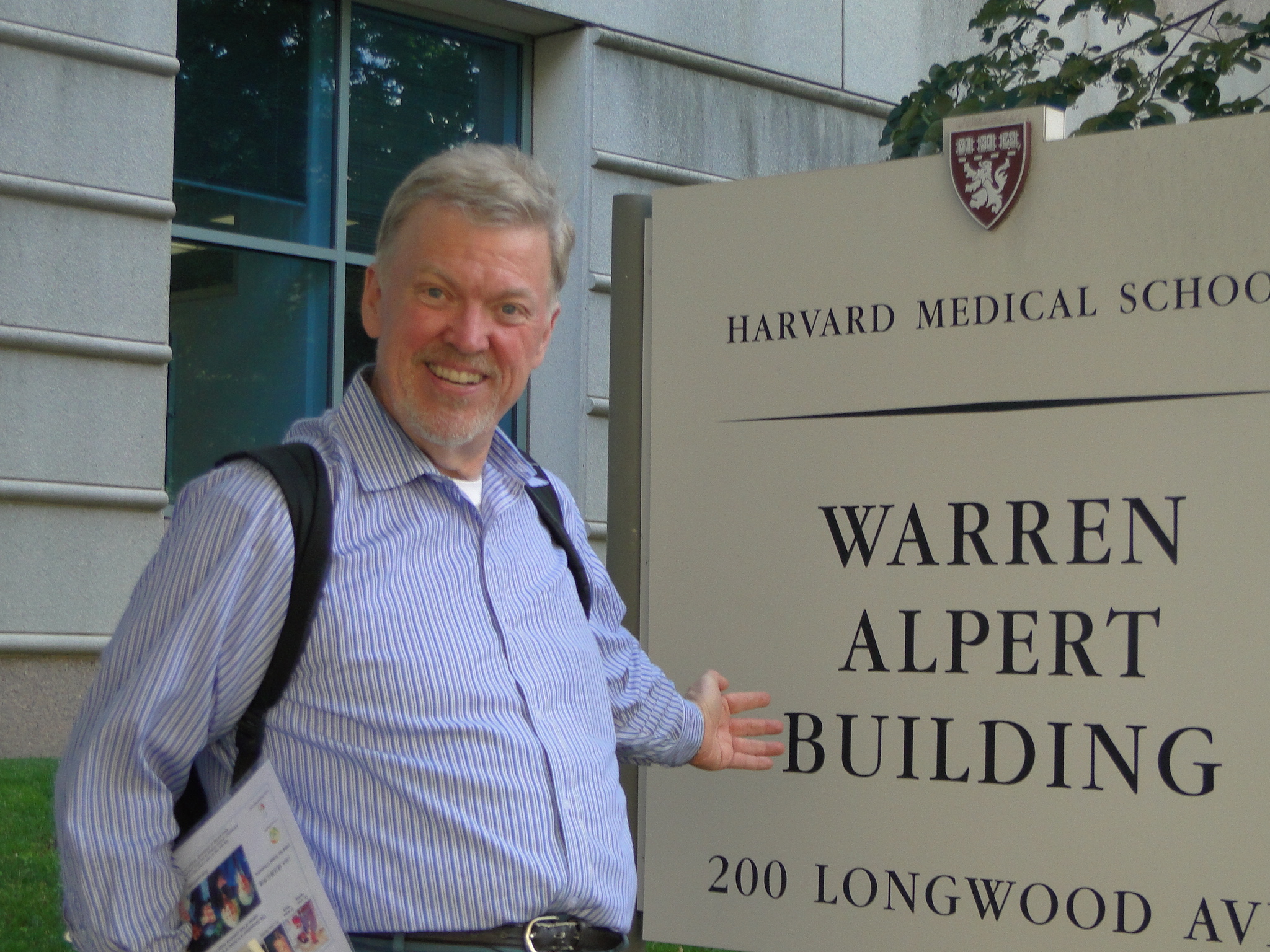 Maynard S. Clark by sign for Warren Alpert Building at Harvard Medical School; he was involved in some of the fundraising effort